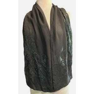 May include: A black shawl with sequin and beaded detailing. The shawl features a draped design with a smooth, dark fabric and intricate patterns along the edges. The sleeves are heavily embellished with sequins and beads.