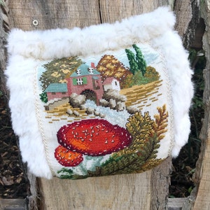 Handmade muff with vintage embroidery of a toadstool