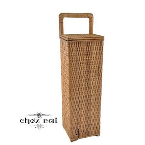 May include: A tall, woven wicker storage basket with a lid and a handle. The basket is brown and has a natural finish.