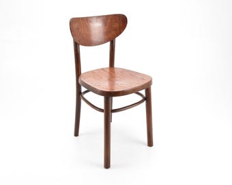 May include: A wooden chair with a curved back and a brown finish. The chair has a simple design with four legs and a seat.