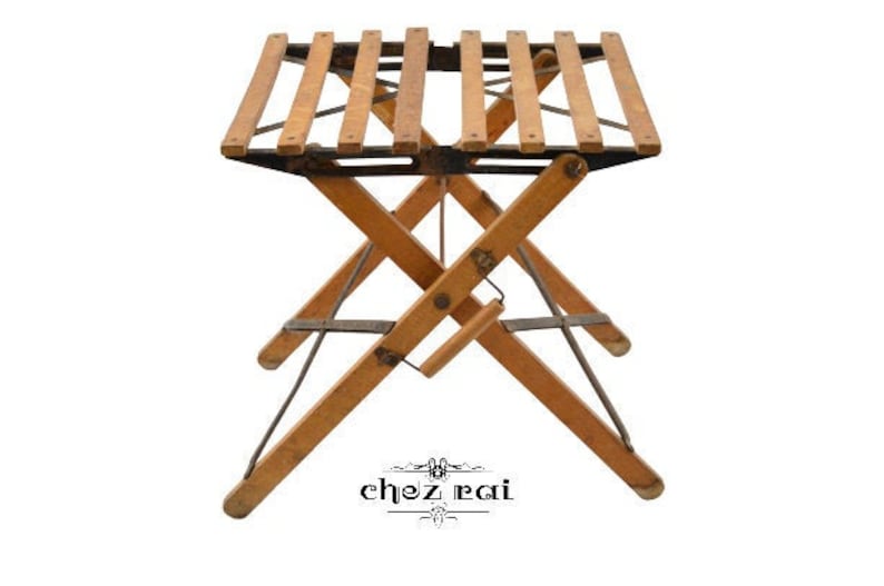 May include: A wooden folding table with a slatted top and black metal supports. The table is in a folded position, with the legs crossed.