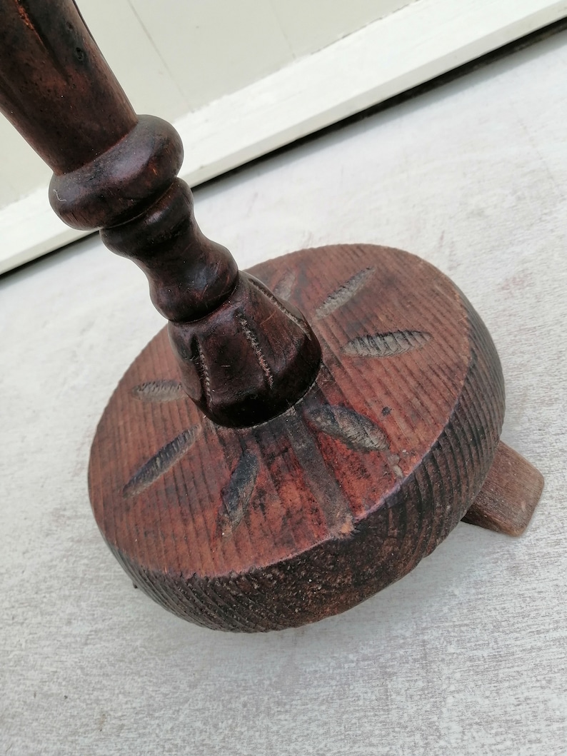 K&ouml;nnte beinhalten: Ein dunkelbrauner Holz-Dreifu&szlig;st&auml;nder mit einem geschnitzten Sockel und einer gedrehten S&auml;ule. Der St&auml;nder hat einen runden Sockel mit einem geschnitzten Design.
