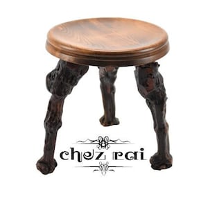 May include: A wooden stool with three legs that are carved to look like tree branches. The stool has a round, brown top.