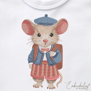 May include: Embroidered design of a mouse wearing a blue jacket, shorts, and a matching hat, with a brown backpack and a pink bow tie. The mouse has large ears and a pink nose. The design is on a white background.