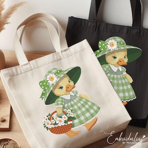 May include: Two canvas tote bags with embroidered images of a duck wearing a green and white gingham dress and a white hat with daisies. The duck is holding a basket of daisies. The text "Embroidarling by RivusDe" is on the bottom of the bag.