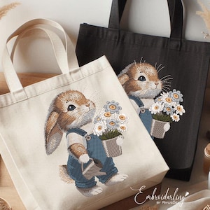May include: Two canvas tote bags with embroidered images of brown bunnies holding buckets of flowers. The bunny on the left is wearing blue overalls and holding a watering can. The bunny on the right is wearing blue overalls and holding a bucket of flowers. The text "Embroidarling by RivusDea" is at the bottom of the image.