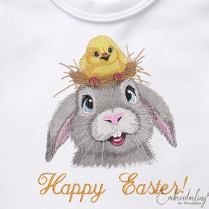 May include: Embroidered design of a gray bunny with a yellow chick sitting in a nest on its head. The bunny has pink ears and blue eyes. The text "Happy Easter!" is written in yellow below the bunny.