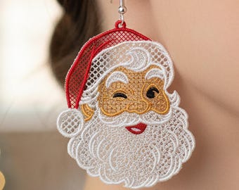 May include: A Santa Claus-themed earring with a winking face, red hat, and white beard. The earring is made of a delicate, open-weave material, with a silver hook. The design features gold, red, and white colors, perfect for the holiday season.