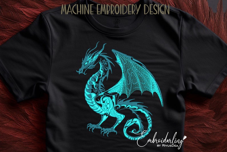 May include: Machine embroidery design of a teal blue dragon with wings spread wide. The dragon is on a black t-shirt.