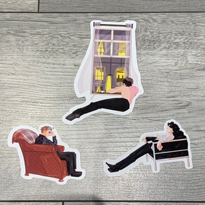 May include: Three stickers featuring illustrations of people in different poses. One sticker shows a person sitting in a chair, another shows a person sitting in a window, and the last sticker shows a person sitting in a chair with their legs crossed.