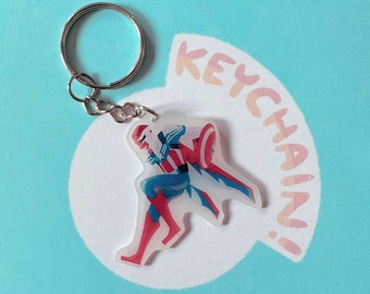 May include: A red, white, and blue superhero character keychain with a silver key ring. The keychain is made of clear acrylic and features a character with a cape and a shield.