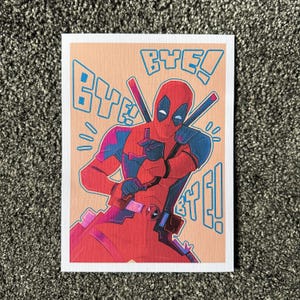 May include: A red and black Deadpool character illustration with a red and black suit, a red mask, and a black eye mask. The character is holding two katanas and is saying "Bye!" in a blue and pink font.