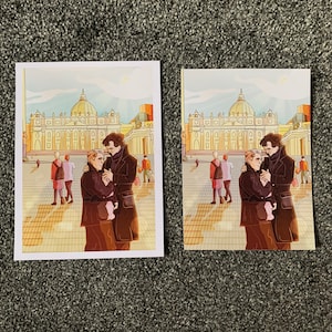 May include: Two people in black coats stand in front of a large building with a dome. The building has a yellow facade and white trim. The people are looking at each other and smiling. The building is in a city setting with other buildings in the background.