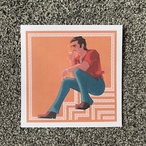 May include: A digital illustration of a man sitting with his legs crossed, wearing a red shirt and blue jeans. He is holding a cigarette in his right hand and looking to the side. The background is a peach colour with a white border.