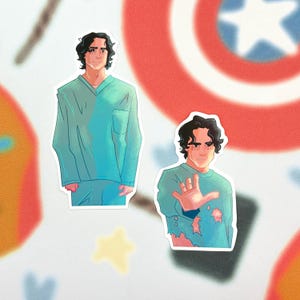 May include: Two stickers featuring a male figure in teal scrubs. One sticker shows the figure standing, the other shows the figure with a hand raised. The background includes a red and white shield design and a yellow star.