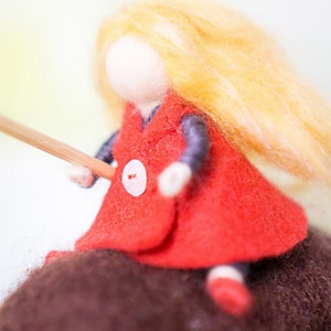 Felt sculpture of wild brown bear and tiny girl in red cloak. The figurine of huntress with lamp. image 4