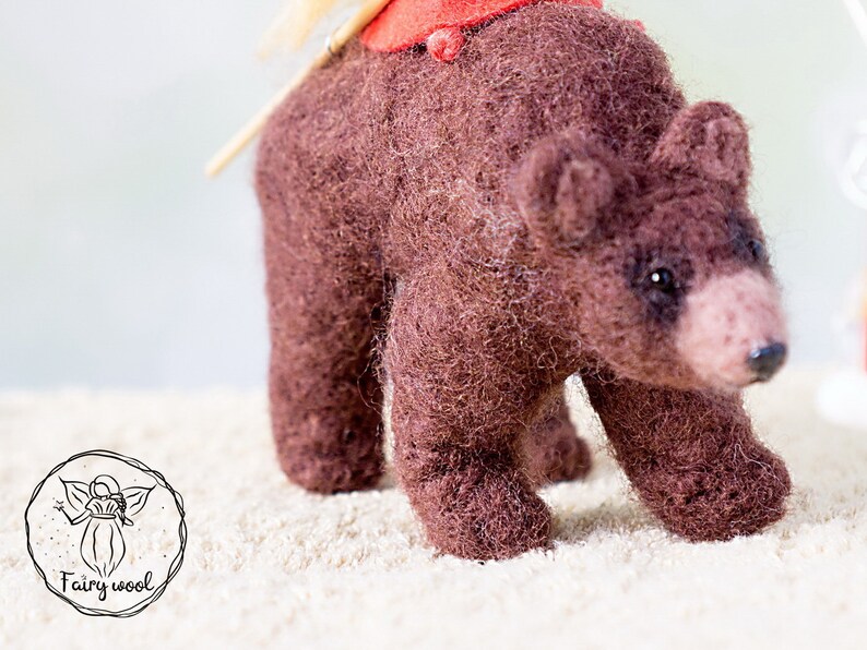 Felt sculpture of wild brown bear and tiny girl in red cloak. The figurine of huntress with lamp. image 7