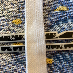 May include: White cotton twill tape measuring 1 1/2 inches wide.