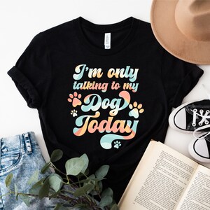May include: Black t-shirt with a retro-style graphic that says "I'm only talking to my dog today".