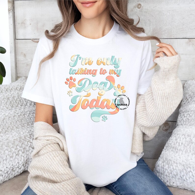 May include: White t-shirt with a colorful graphic that says "I'm only talking to my dog today".