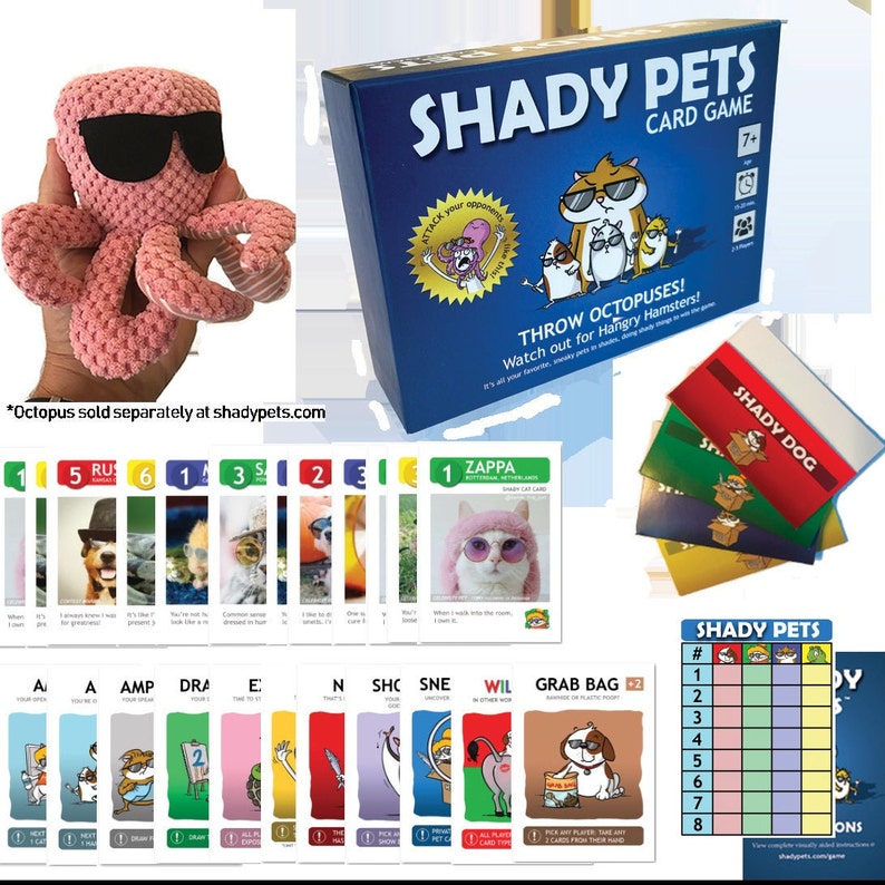 May include: A pink crocheted octopus wearing sunglasses next to a blue box of the "Shady Pets" card game. The game includes various cards with animal illustrations and the text "Shady Dog".