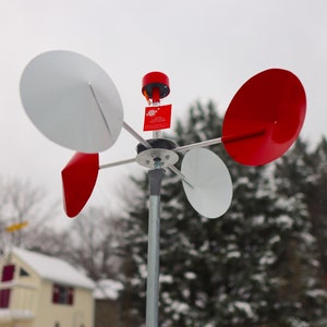 A horizontal spinning whirligig. A wind art spinner.