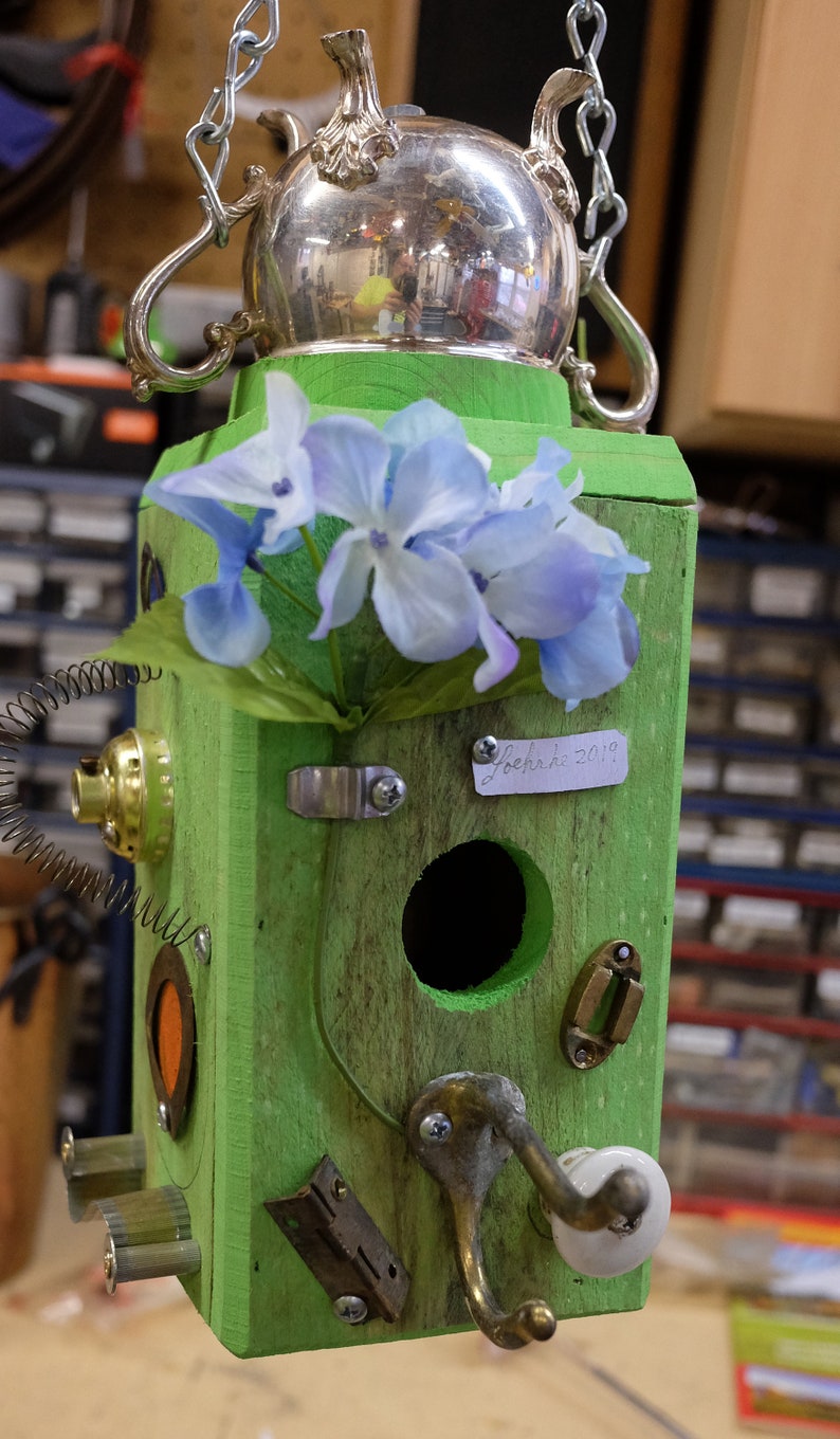 Birdhouse with teapot creamer roof, found items, car parts and a Birdhouse with teapot creamer roof, found items, car parts and a