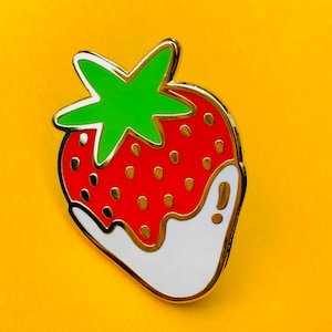 A juicy strawberry dipped in cream hard enamel pin badge, a great gift for your fruity tennis friends!