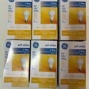 May include: Six boxes of GE soft white 3-way light bulbs. Each box shows a light bulb image, with text indicating 20/135/155W, 120/2080/2200 lumens, and a 1.1-year life. The boxes have a yellow and white color scheme.