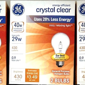 May include: A white ceramic mug with a black handle and the text "But First, Coffee" in a black, handwritten-style font. The mug is on a white surface.