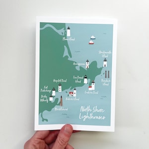 May include: A print featuring a map of the North Shore Lighthouses, with each lighthouse illustrated in black and white. The map is set against a teal and green background, with the words "North Shore Lighthouses" in white.