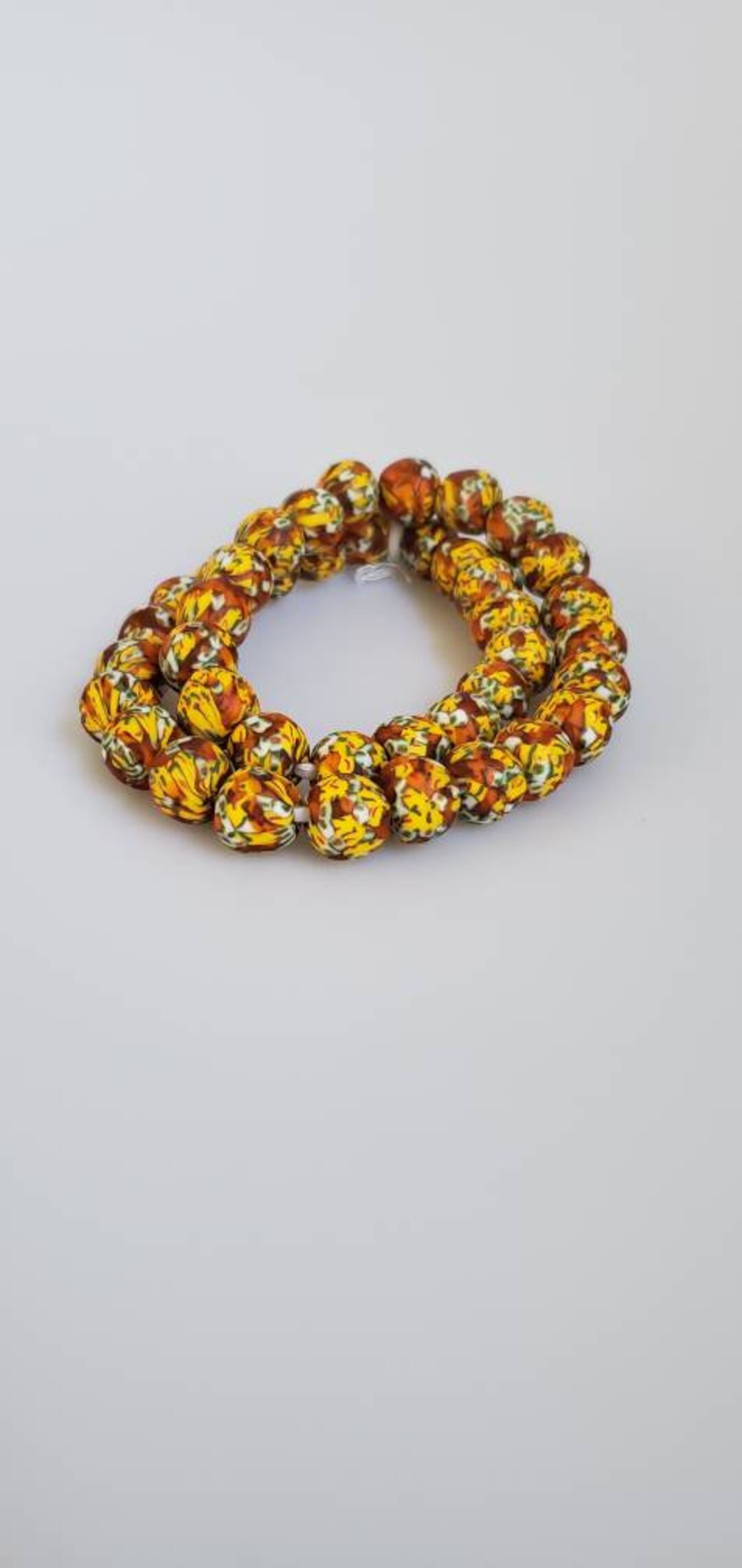 A String of Burnt Orange Yellow White and Green Fancy - Etsy