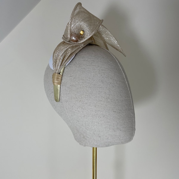 Pale gold Sinamay fascinator.