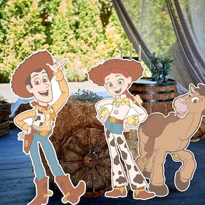 May include: Cardboard cutouts of Woody, Jessie, and a horse from the animated film Toy Story. Woody wears a cowboy hat, vest, and boots. Jessie has a cowgirl outfit. The horse has a saddle. The cutouts are on a wooden surface with a hay bale.