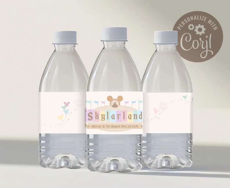 May include: Three clear plastic water bottles with personalized labels. The labels are white with a light blue, pink, and yellow color scheme. The labels feature a cartoon image of Mickey Mouse's head and the text "Skylarland Welcome to the Happiest Place on Earth".