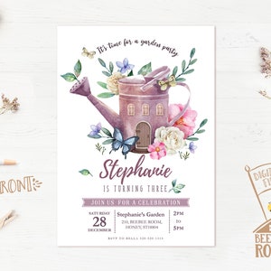 May include: A purple watering can with a house-shaped design, surrounded by flowers and butterflies. The text "Stephanie is turning three" is written below the watering can. The invitation is for a garden party on Saturday, December 28th from 2pm to 5pm.
