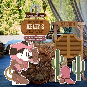 May include: A pink and brown cartoon mouse wearing a pink cowboy hat and a pink vest with a lasso. The mouse is standing in front of a wooden sign that says "Howdy, Partner! Welcome to Kelly's Wild West Kick up your boots and mosey on in!" There is also a wooden saloon door with a sign that says "SALOON".