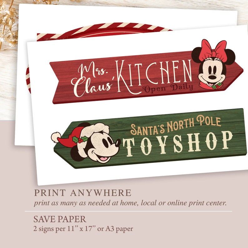 May include: Two printable Christmas signs featuring Mickey Mouse and Minnie Mouse. The red sign says "Mrs. Claus Kitchen - Open Daily". The green sign says "Santa's North Pole Toy Shop".