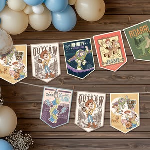 May include: A banner garland featuring illustrations and text from the Toy Story franchise. The pennant-shaped banners are strung together with white string. Balloons in shades of blue, white, and beige are in the background, creating a festive atmosphere.