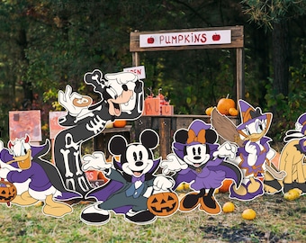 May include: A group of Disney characters dressed in Halloween costumes stand in front of a pumpkin stand. Mickey Mouse is dressed as a vampire, Minnie Mouse is a witch, Donald Duck is a devil, Goofy is a skeleton, Daisy Duck is a witch, and Pluto is a ghost.