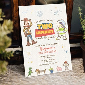 May include: A rectangular birthday invitation card featuring hand-drawn style illustrations of cartoon characters. The text reads: Get ready for fun, Two Infinity and beyond, Please join us to celebrate Benjamin's 2nd Birthday, Saturday, 28th December, 3pm to 5pm, 123 W Parmer Street, Austin, Texas, RSVP to Becky 012 345 6789.