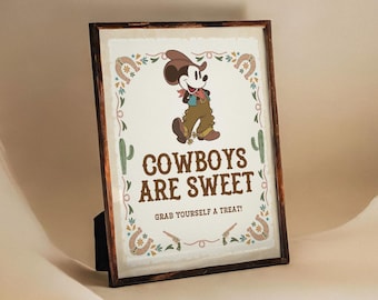 May include: A framed print with a cartoon image of Mickey Mouse dressed as a cowboy. The print has a brown background with a floral design and the text "COWBOYS ARE SWEET. GRAB YOURSELF A TREAT!"