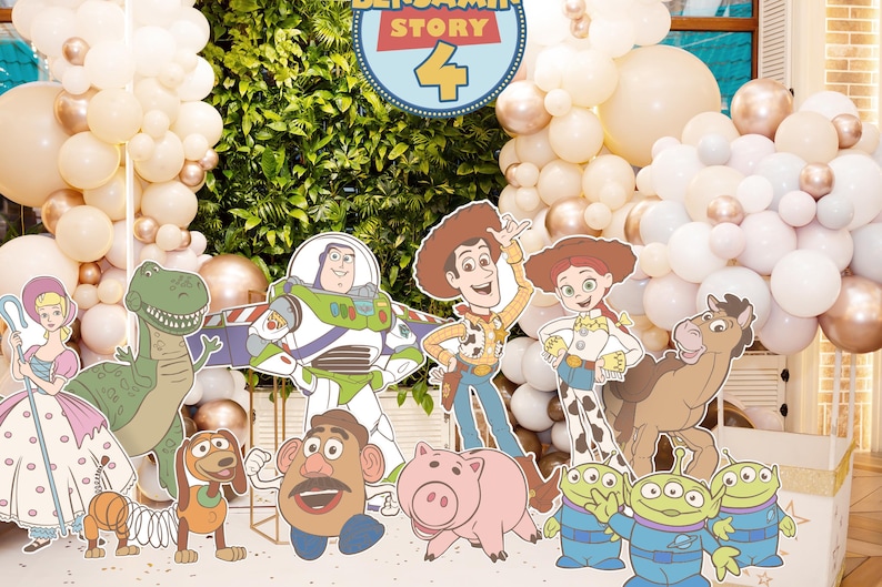 May include: A party scene with Toy Story character cutouts, such as Woody, Buzz Lightyear, and Jessie, set against a backdrop of white, gold, and peach balloons. The decorations are themed for a Toy Story 4 event.
