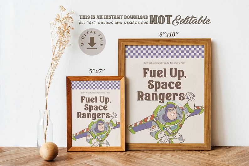 May include: Two framed prints with a wooden finish. The prints feature the text "Fuel Up, Space Rangers" and an illustration of Buzz Lightyear. The larger print is 8"x10", and the smaller is 5"x7".