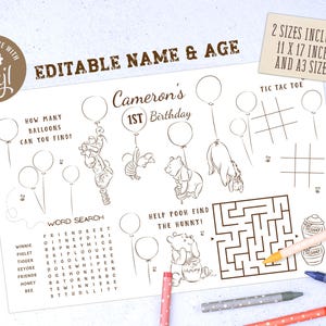 May include: A white activity sheet with Winnie the Pooh illustrations, a word search, and a maze. The text reads "Cameron's 1st Birthday" and "Editable Name & Age." Includes tic-tac-toe and "How many balloons can you find?" with crayons.