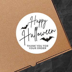 May include: White circle sticker with black bats and the text "Happy Halloween" and "Thank you for your order".