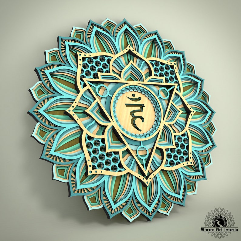 May include: A layered wooden wall art piece in a mandala design. The artwork features a central geometric shape with a symbol, surrounded by layers of teal, tan, and brown floral patterns. The piece is three-dimensional, creating depth and shadow.
