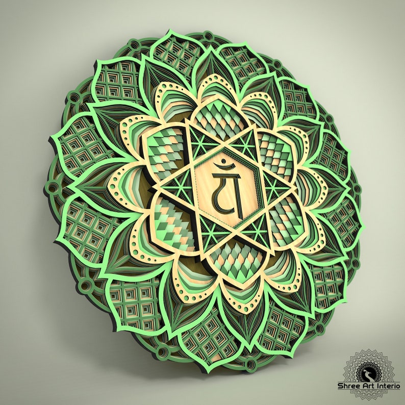 May include: A layered wooden mandala in shades of green, tan, and black. The design features a central geometric shape with a symbol, surrounded by intricate floral patterns. The artwork is a decorative wall hanging.