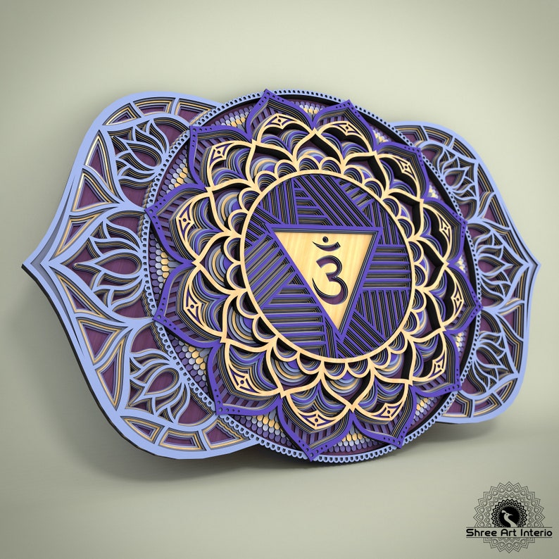 May include: A layered wooden wall art piece featuring a detailed mandala design. The artwork showcases concentric circles and intricate patterns in shades of purple, blue, and gold. A central triangle contains a symbol. The piece is designed to be mounted on a wall.