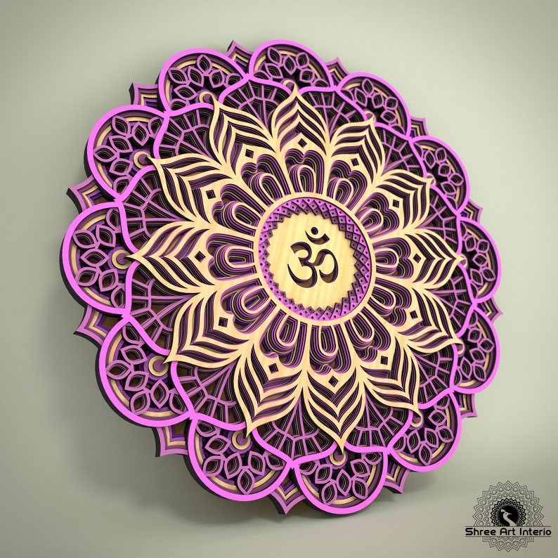 May include: A layered wooden mandala in shades of pink, purple, and beige. The design features intricate floral patterns and a central circle with the Om symbol. The artwork is a decorative piece for wall decor.